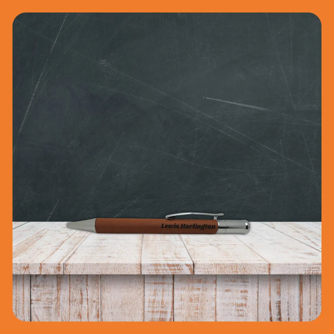 A brown pen resting on a wooden table against a chalkboard backdrop.