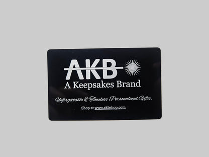 Black card with 'AKB' branding on a textured gray background