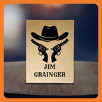 A western-themed graphic featuring a cowboy hat and two revolvers, with the name 'Jim Grainger' at the bottom.