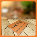 A personalized leather notebook with a floral design on a wooden table.