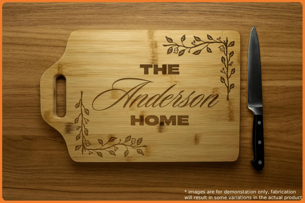 Wooden cutting board with engraved text 'The Anderson Home' and decorative vines, accompanied by a knife.