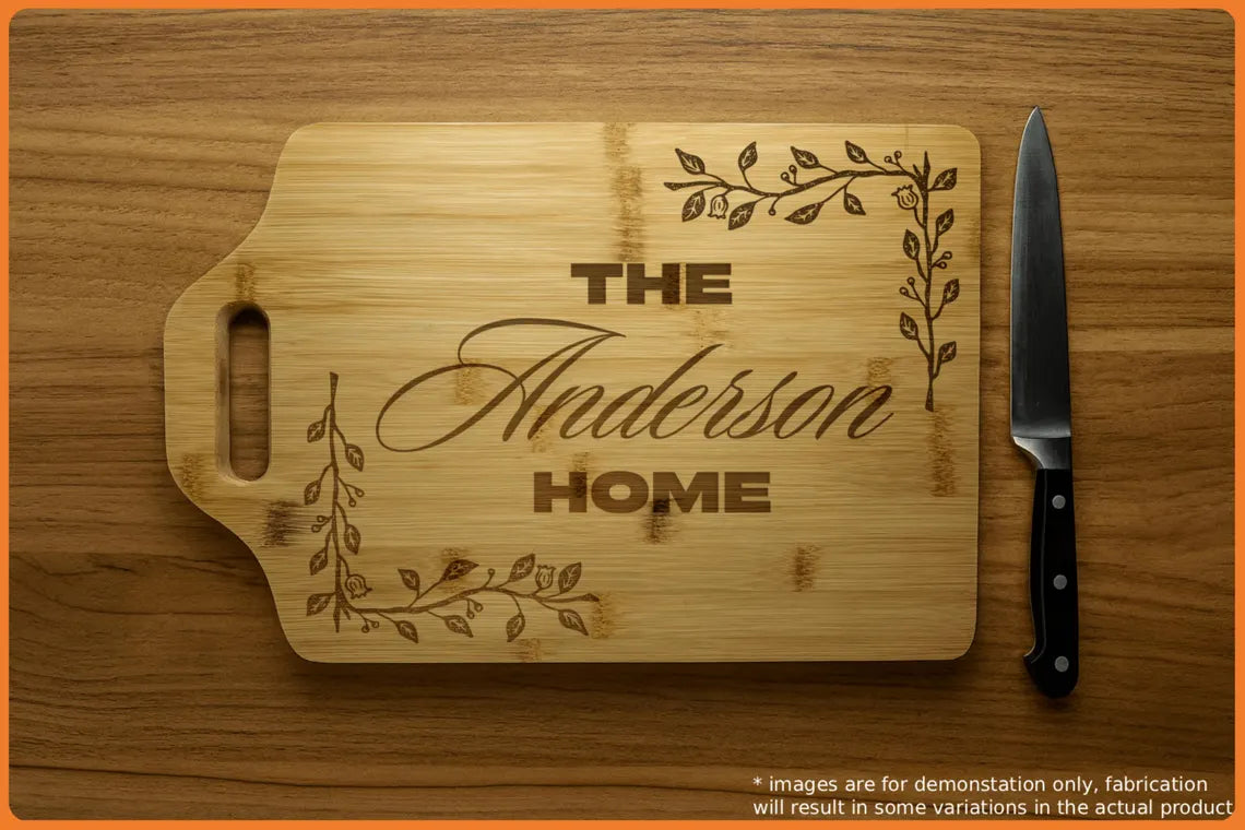 Wooden cutting board with engraved text 'The Anderson Home' and decorative vines, accompanied by a knife.