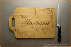 Personalized wooden cutting board with the name 'Jackson Family' and a knife beside it.